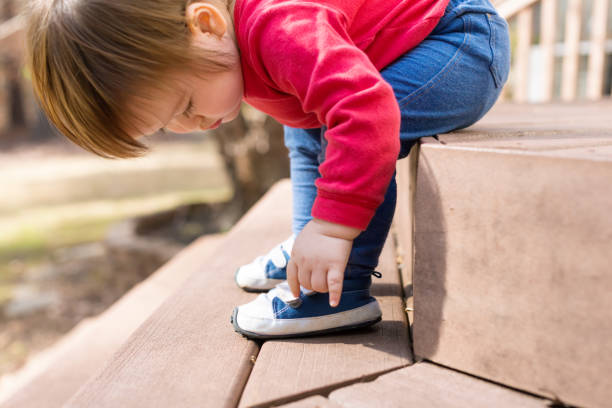 istock Happy toddler boy tying his sneakers 1133468449