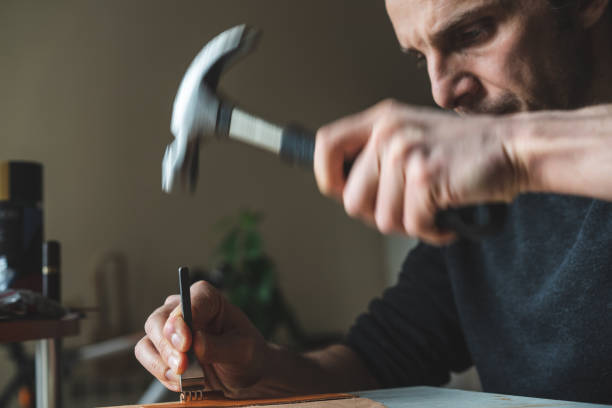 Craftsman punches a leather detail stock photo