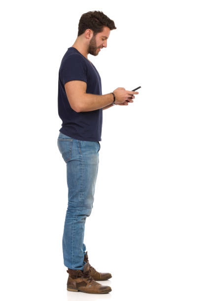istock Side View Of Full Length Standing Man Using Telephone. 1133469205