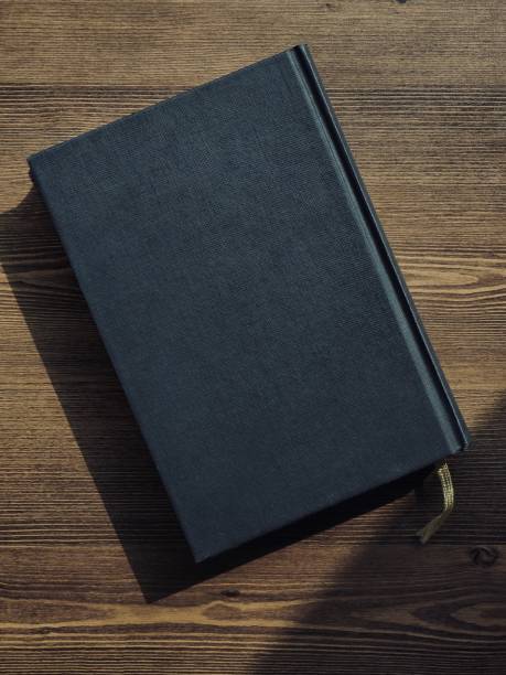 istock Wooden board and black book 1133471582