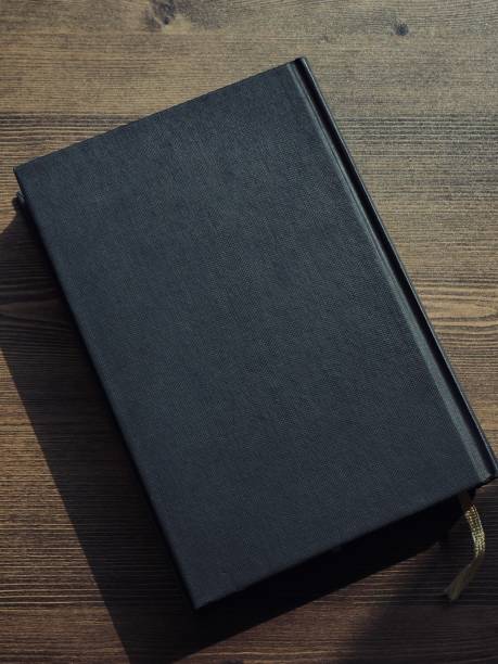 istock Wooden board and black book 1133471590