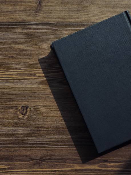 istock Wooden board and black book 1133471593
