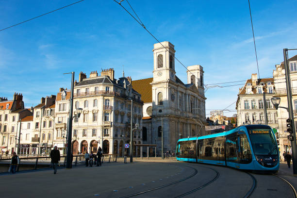 View of the city of Besançon,France. Besançon,France-12 22 2014: A tramway is passing nearby the Sainte Madeleine church building in the city center of Besançon in Franche-Comté, France. jura france photos stock pictures, royalty-free photos & images
