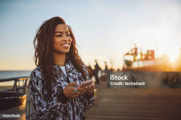Young Fashionable Woman Texting On Her Phone In Santa Monica La Stock Photo - Download Image Now