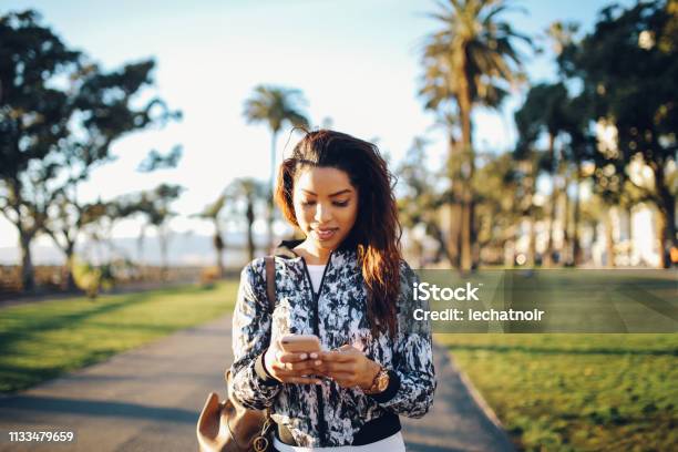 Young Fashionable Woman Texting On Her Phone In Santa Monica La Stock Photo - Download Image Now