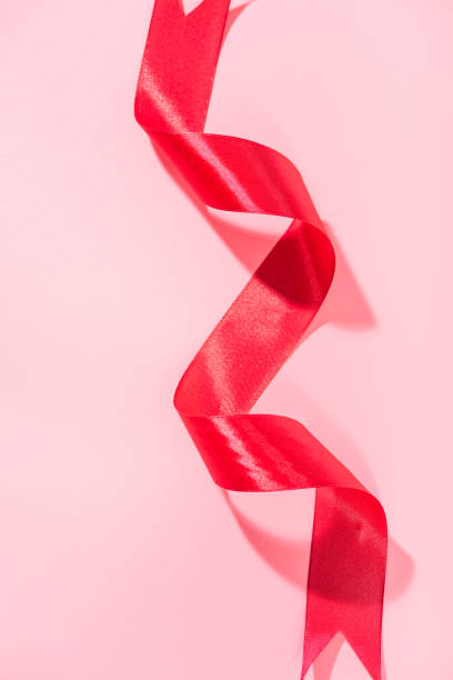 istock Red ribbons on a pink background 1133481669