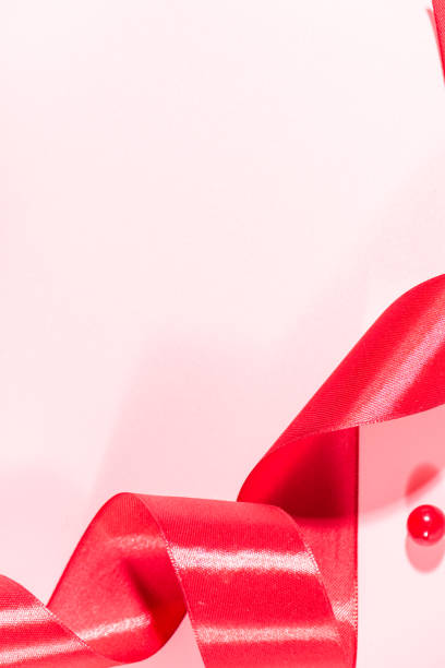 istock Red ribbons and beads on a pink background 1133481682