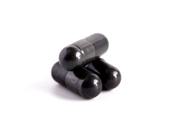 istock A Pile of Three Activated Charcole Capsules 1133481917