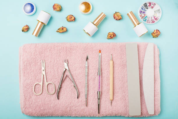 istock Manicure tools on a pink towel and a blue background. Manicure background. 1133485334