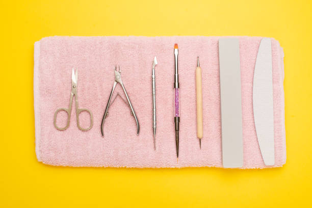 istock Manicure tools on a pink towel and a yellow background. Manicure background. 1133485867