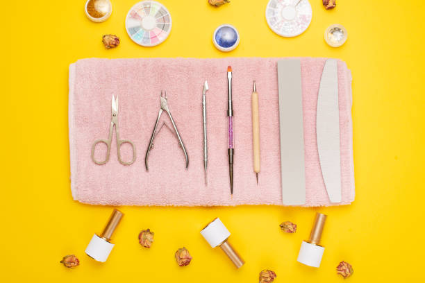 istock Manicure tools on a pink towel and a yellow background. Manicure background. 1133485900