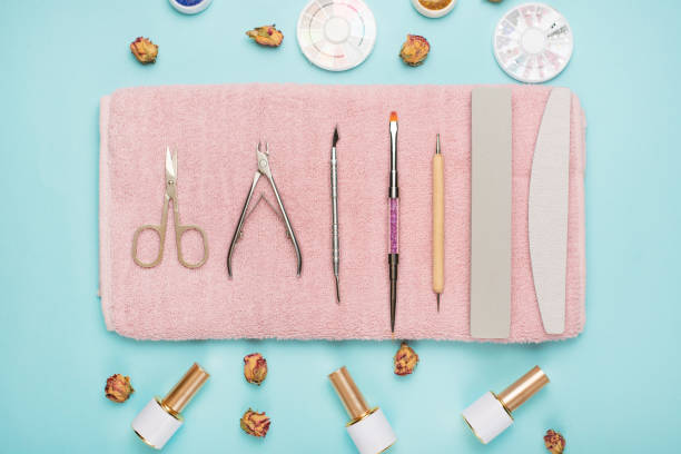 istock Manicure tools on a pink towel and a blue background. Manicure background. 1133485948