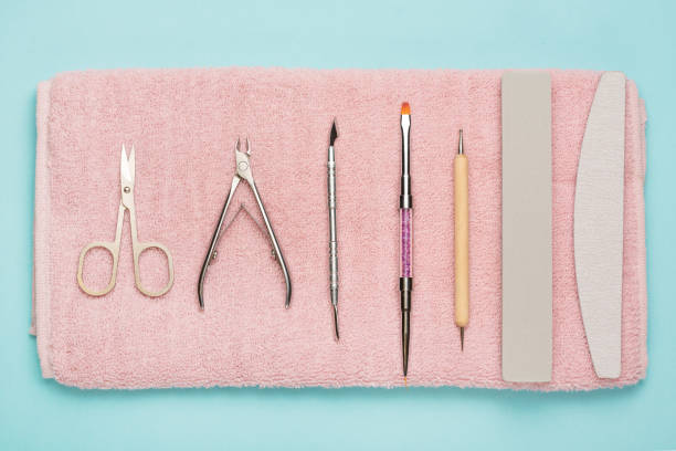 Manicure tools on a pink towel and a blue background. Manicure background.