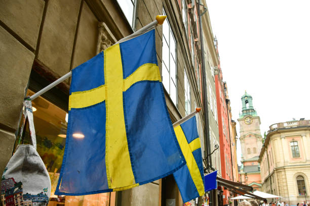 swedish flag in old town stockholm stock photo