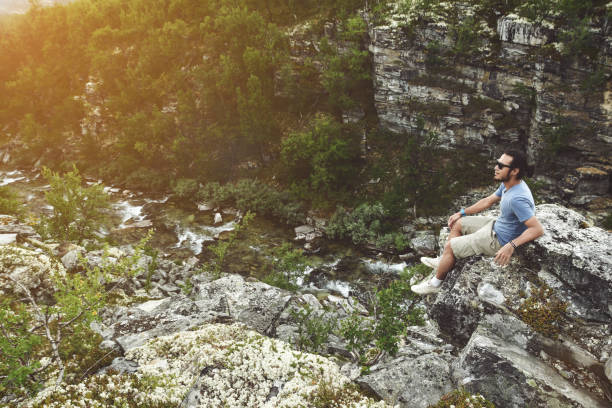istock Man on a cliff at storulfossen Norway 1133490460