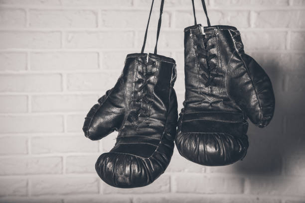 istock Hanging Boxing gloves on brick wall background 1133490560