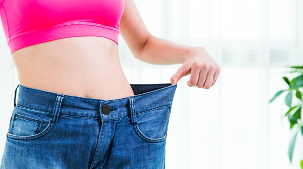 istock Young woman in big jeans 1133493221