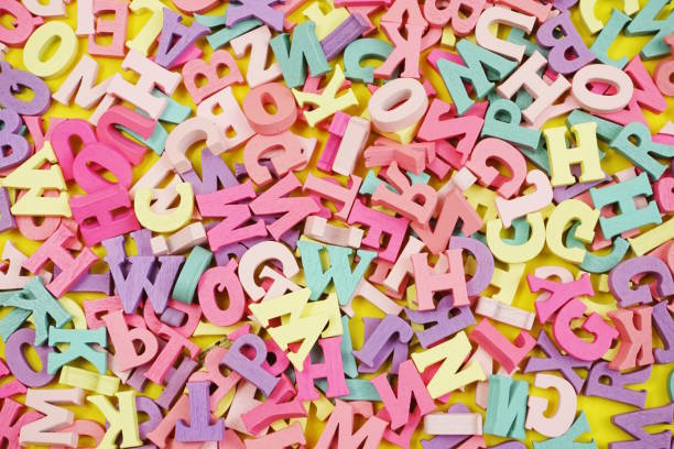 istock random colorful letterpress alphabet top view on yellow background 1133493985