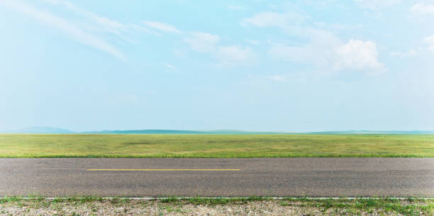 Side view of empty asphalt road and green field Side view of empty asphalt road and green field. road panoramic scenics journey stock pictures, royalty-free photos & images