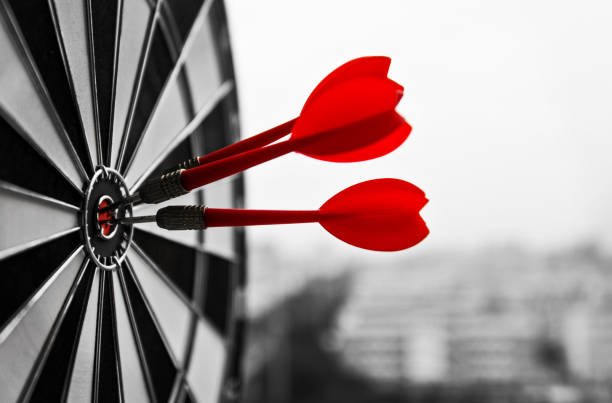 Dart board with three darts outdoors Dart board with three darts outdoors. bulls eye photos stock pictures, royalty-free photos & images