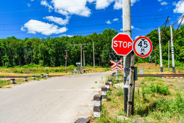stop sign in front of the railroad crossing - railroad crossing railway signal gate nobody imagens e fotografias de stock