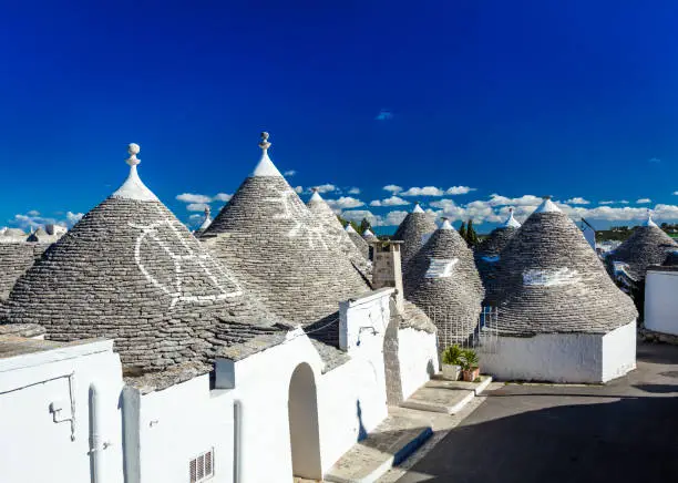 Trulli houses of Alberobello, Italy with characteristics symbols on the roofs