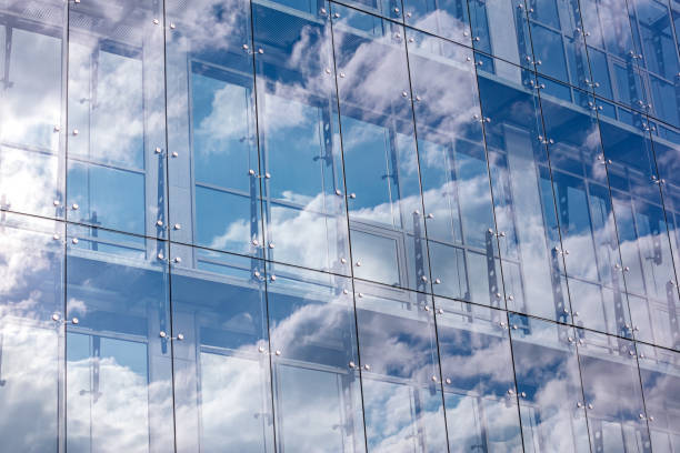 istock glass wall of modern office building with cloudy sky reflection 1133503638