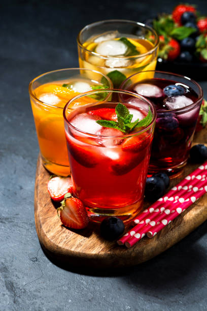 istock cold fruit and berry beverages in assortment on dark background, vertical 1133508009