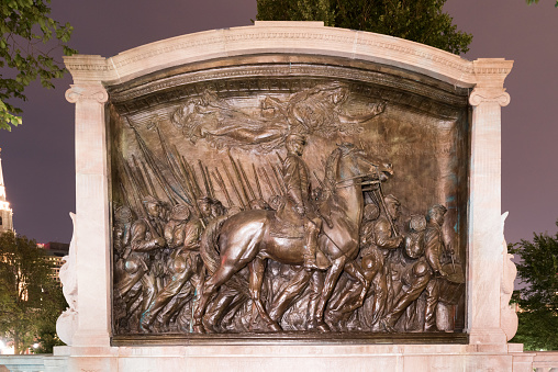 The Robert Gould Shaw and Massachusetts 54th Regiment Memorial, located across Beacon Street from the State House at night.