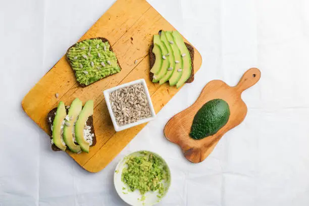 Avocado toast breakfast with sunflower seeds and rye bread. Top view