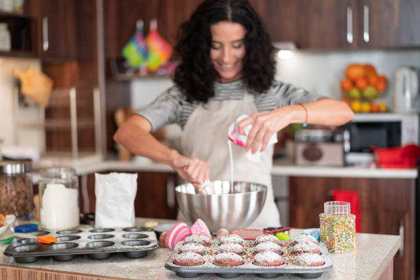 istock Confectioner woman making delicious cream for cupcakes 1133512112
