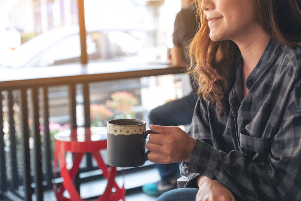 istock Asian woman smelling and drinking hot coffee with feeling good 1133512972