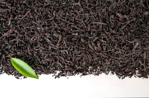 istock Black and green tea leaves with white background 1133515503