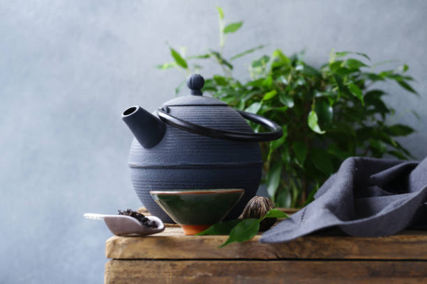istock cast iron kettle on wooden table 1133515649