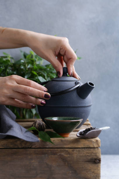 istock cast iron kettle on wooden table 1133515757