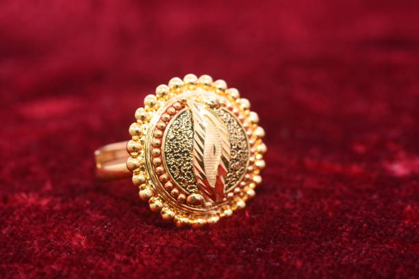 Fancy designer precious jewelry golden ring closeup macro image on red background for woman Fancy designer precious jewelry golden ring closeup macro image on red background for woman diamond shaped photos stock pictures, royalty-free photos & images