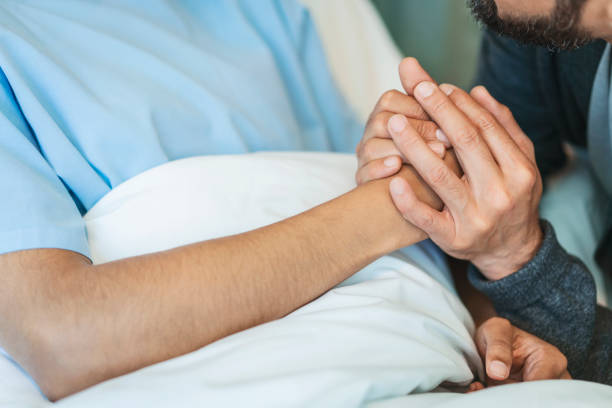 istock Man is consoling woman by holding her hand 1133517746