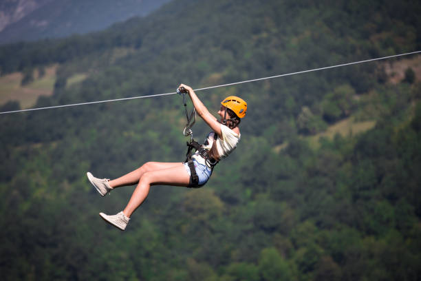 Riding on a zip line Riding on a zip line zip line stock pictures, royalty-free photos & images