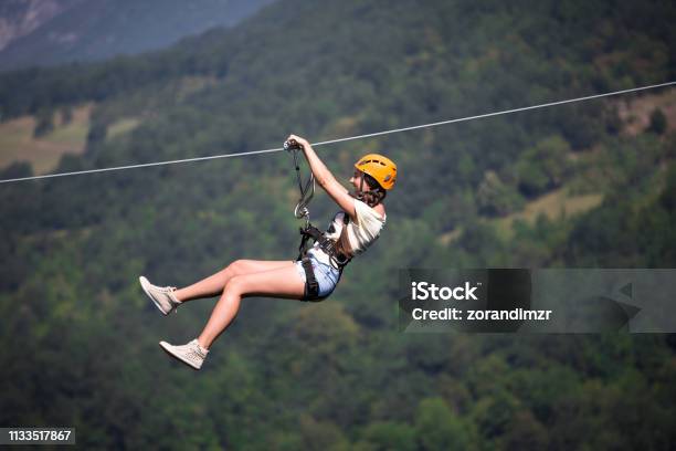 Riding On A Zip Line Stock Photo - Download Image Now - Zip Line, Women, Nature