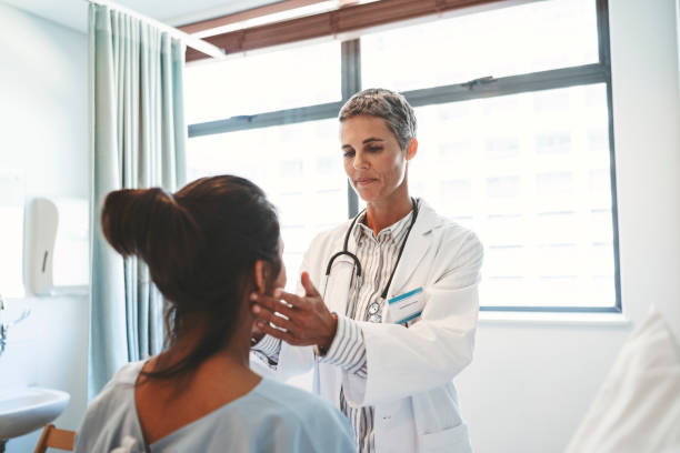 istock Doctor examining patient in hospital ward 1133517871