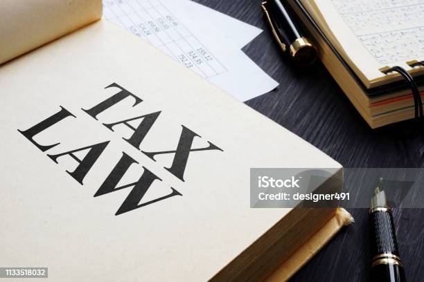 Tax Law And Accounting Report On A Table Stock Photo - Download Image Now - Tax, Law, Legal System