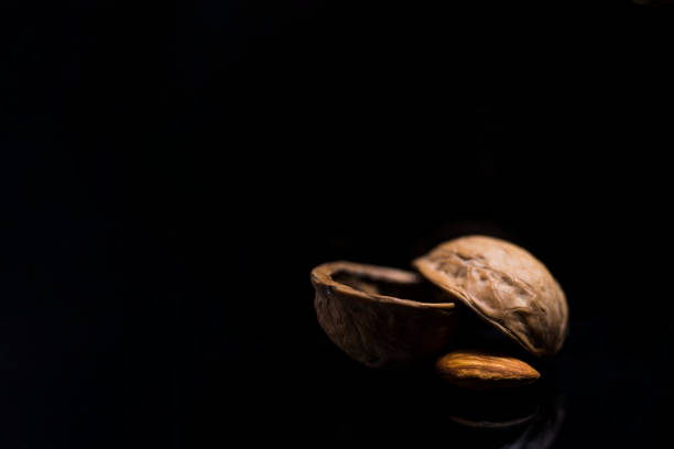 The fruit of the almond is a drupe, consisting of an outer hull and a hard shell with the seed, which is not a true nut, inside. \