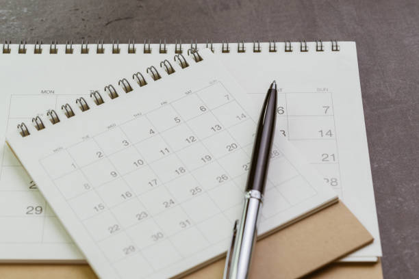 istock White clean calendar with pen on dark blackboard desk using as reminder, plan or personal diary concept 1133519683