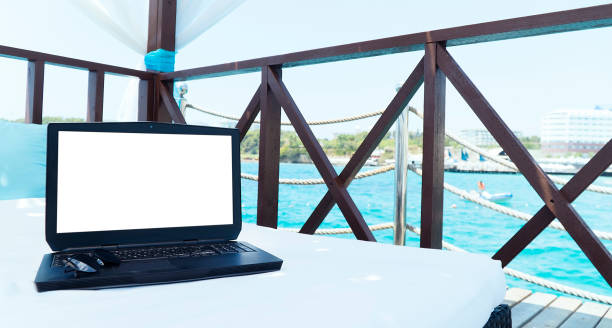 istock Laptop with copy space on the bed in summer place 1133521552