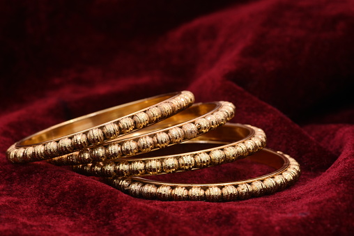 Fancy designer golden bracelets / bangles jewelry closeup macro image for woman fashion