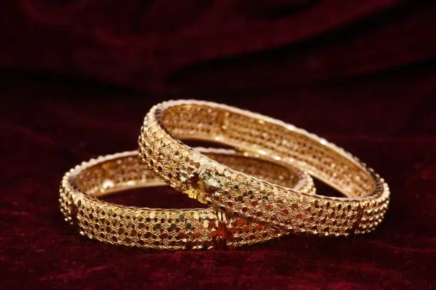 Photo of Fancy designer golden bracelets / bangles jewelry closeup macro image for woman fashion