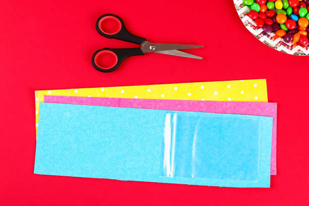istock Diy Easter wrapping package sweets in a bag with a cut out bunny silhouette on a red background. 1133523292