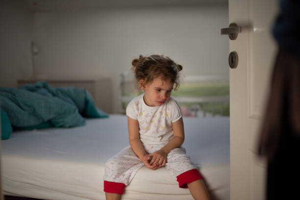 Little girl crying in bedroom Focus on a little girl crying in bedroom. Father is punishing her. child abuse photos stock pictures, royalty-free photos & images