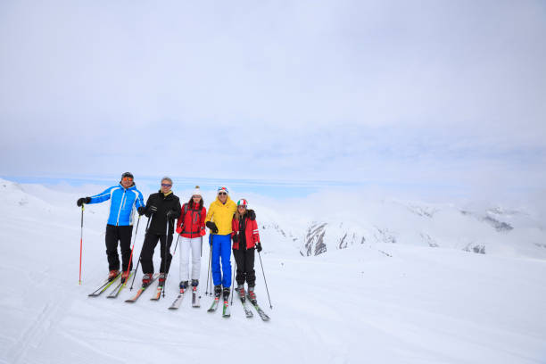 Amateur Winter Sports  alpine skiing. Group of skiers. Best friends men and women, snow skiers, enjoying  skiing.  High mountain snowy landscape. Livigno mountain range, Alps. It is located in the Italiy. Amateur Winter Sports  alpine skiing. Group of skiers. Best friends men and women, snow skiers, enjoying  skiing.  High mountain snowy landscape. Livigno mountain range, Alps. It is located in the Italiy. lombardy photos stock pictures, royalty-free photos & images