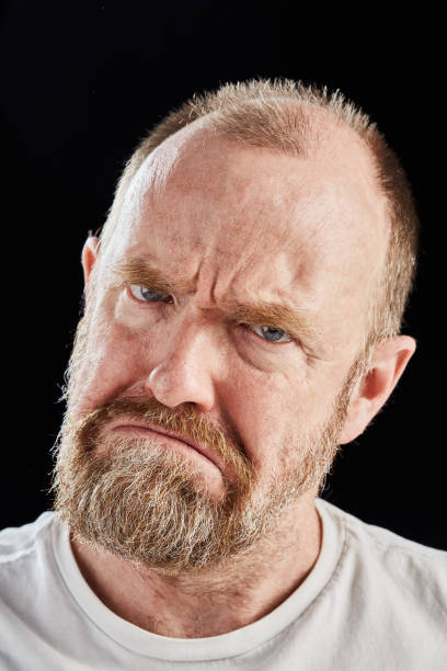 istock Mature bearded man frowns, looking angry 1133528021